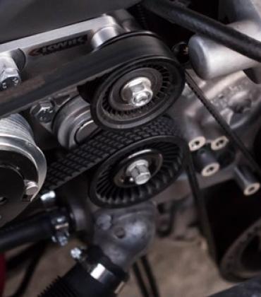 Nahaufnahme eines Motors mit einem Riemen, die die technischen Details zeigt