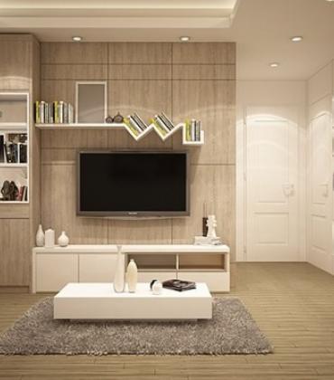 Modernes Wohnzimmer mit hellen Möbeln und einem Fernseher an der Wand.  